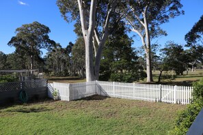 the secure yard in front of Little Finchley's gated verandah