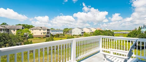 Enjoy a cup of coffee on the private balcony overlooking sprawling marsh views