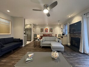 Open living room with space to relax, watch TV, and read after the beach.  