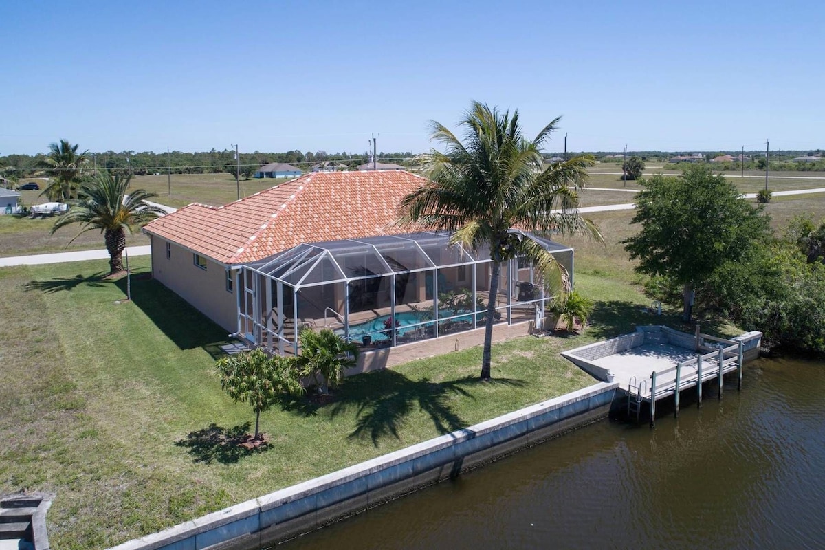 Tommy Bahama-style electric-heated pool home on Gulf-access canal – Villa Ellis