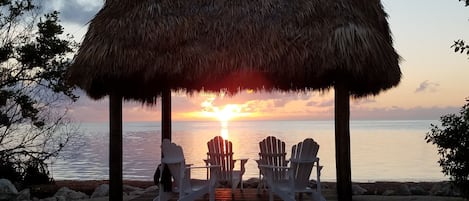 tiki hut on shared oceanside beach