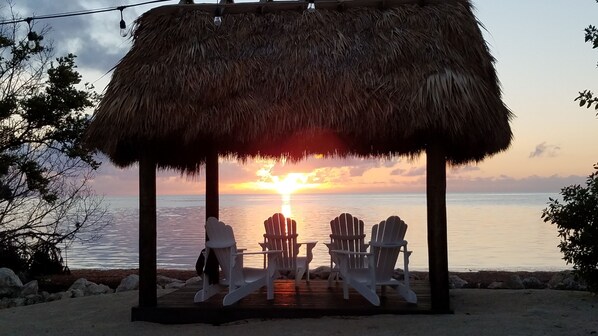 tiki hut on shared oceanside beach