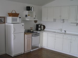 The kitchen has everything for dining in...wine glasses to picnic baskets.
