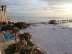 View from balcony of heated pool, tiki hut, and fishing pier