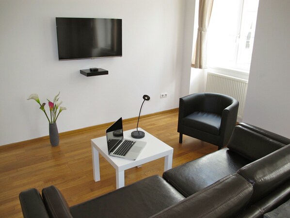 Living area with our 42' TV and a single round designer coutch