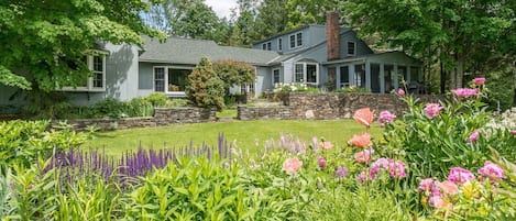 View of back of home and gardens from field