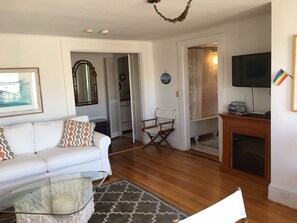 Living area with kitchen and bathroom off to right.