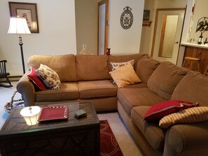 Living room looks out on the river. Wood burning fireplace, flat screen TV & fan