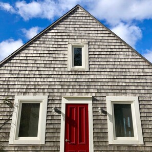 Cape-Breton-style shingled cottage.