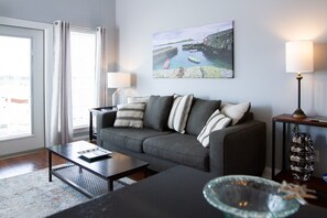 sofa in the living area facing the flat screen tv and the spectacular view