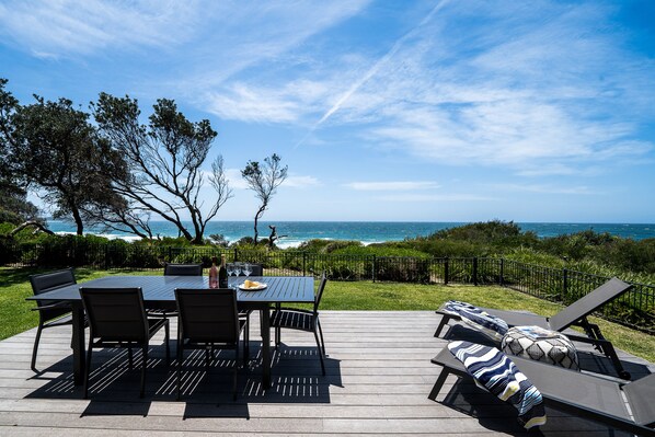 Private north facing beachfront with deck opening directly from lounge room