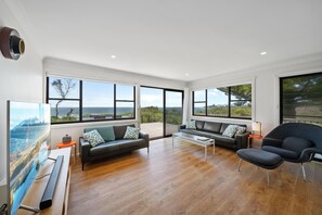 Lounge room opens directly to the deck + has large smart TV with Foxtel