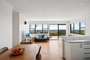 Dining area overlooks the lounge and deck