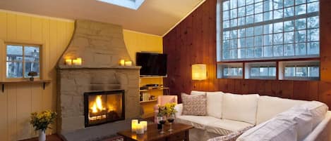 Cozy up to a fire in the gas-fueled fireplace under skylights + oversize windows