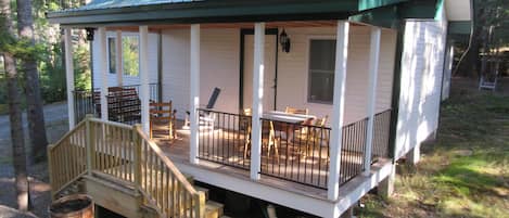 The front porch of the Kerr Cottage with sitting area & game/puzzle table