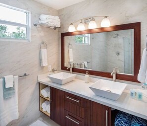 Experience the utmost luxury in our deluxe master bathroom, complete with a spacious walk-in shower