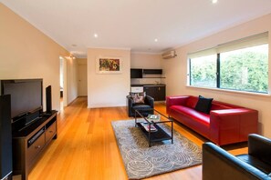  A second living area with a kitchenette and TV provides a great space to retreat, whether for watching movies, playing games, or enjoying a quiet moment.