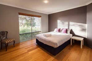  Another bright and inviting bedroom, furnished with a queen bed and soft linens, creating a restful space to recharge.