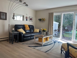 Living room with new (2022) reclining sofa, new floor and coffee table (2024)