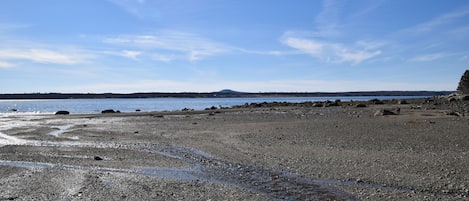 View of shore line of Heather Cove at low tide -expansive views to Blue Hill