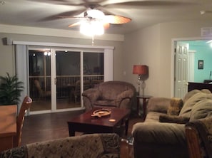 View of living room.  Sliding glass doors take you to the screened in balcony.