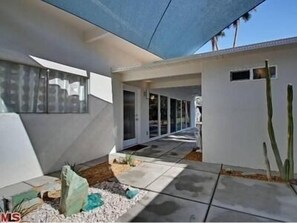 Courtyard entry to private back garden and pool area. Water fountain feature.