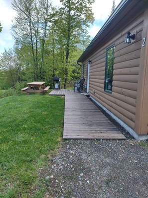 Handicapped accessible with picnic table and gas grill on deck.