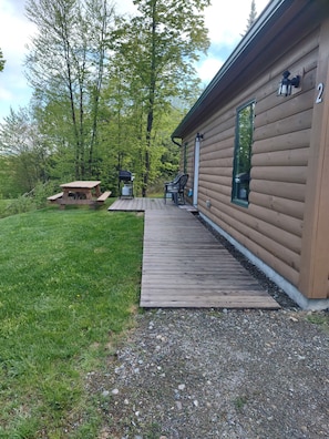 Handicapped accessible with picnic table and gas grill on deck.