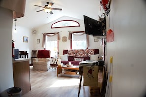 Living area with queen futon, and recliner.