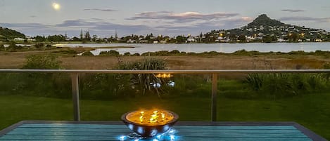 The full moon rises over the estuary. View from the deck.