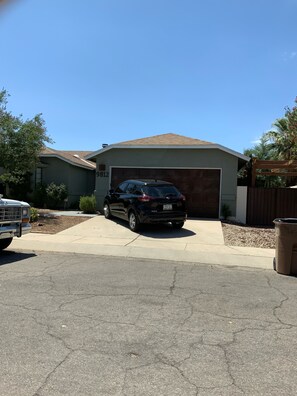 Front of house/rental entrance through right gate under pergola