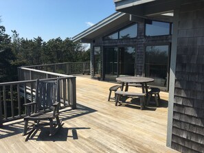 Wrap around deck the length of the house. Three patio tables seat 6-8 each.