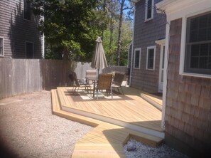 Outdoor dinning and seating area w/ full size Webber Grill.