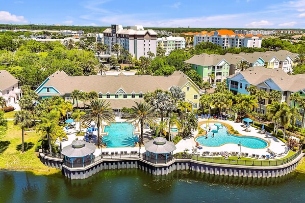 Runaway Beach Club. Fun pools and colorful villas surround small lake.