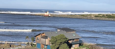 Facing northwest Lighthouse RiverInn at mouth of Coquille river/ Pacific Ocean