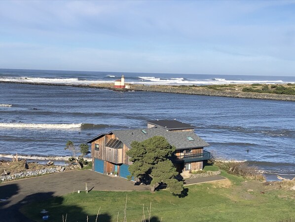 Facing northwest Lighthouse RiverInn at mouth of Coquille river/ Pacific Ocean