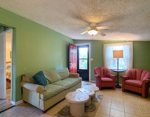 Living room opens up to flower gardens on horse training farm