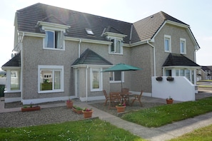 Unit exterior with outdoor dining area.