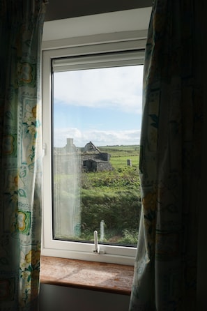 View from the single bedroom: the fields and lovely ruined farmhouse next door.