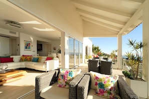 Main terrace opening onto lounge with two sets of bi-fold doors 