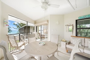 Lounge or dine on the screened-in patio with a sunset view. 