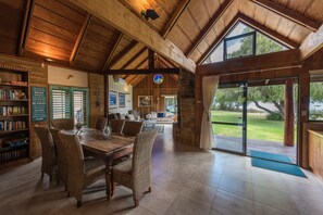 Big dining area and lounge with stunning views of the sheltered beach outside