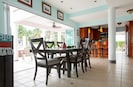 Dining area w/ Beach, Canal & Pool Panoramic Window views.