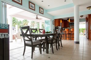 Dining area w/ Beach, Canal & Pool Panoramic Window views.