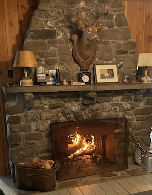 The large fireplace at the Finch Camp warms the cabin right  up. 