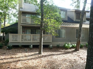 Deck overlooking wooded area.