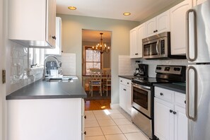 Remodeled kitchen with quarter countertops and stainless steel appliances