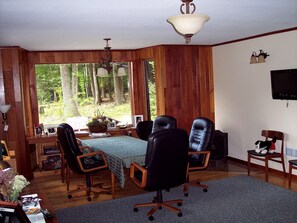 Hardwood floors and cherry wood paneling throughout house