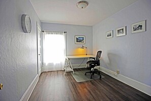 A dedicated full size room with a desk, and office chair for working remotely.