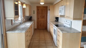 Updated, fully-stocked kitchen (including cooking spices & supplies).